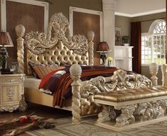 an ornate bed frame with gold paint and wood trimmings, in a bedroom setting