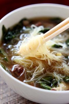 a white bowl filled with noodles and broccoli