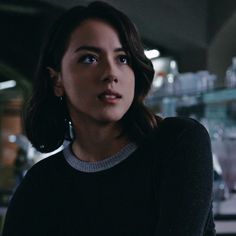 a woman standing in front of a counter top