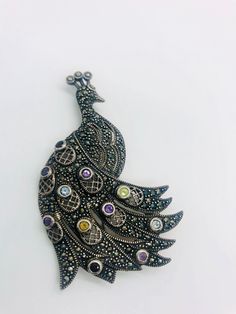 Large magnificent vintage sterling silver gemstone PEACOCK brooch. Heavy sterling silver metal in a large peacock design with marcasites and set with real gemstones. Peridot,amethyst,two colors of topaz and garnets. My pictures do. It do this beauty justice at all. Lovely beaded edged openwork in the feathers. Fully marked and acid tested as sterling silver. Measures 2 7/8 inches tall by 1 7/8 inches wide. Weighs 23gms. In excellent vintage condition condition with minimal age appropriate wear. Antique Silver Multi-stone Brooches, Vintage Silver Jewelry With Peacock Design, Peacock Brooch, Interchangeable Earrings, Sterling Silver Owl, Vintage Designer Jewelry, Vintage Fine Jewelry, Peacock Design, Vintage Designer