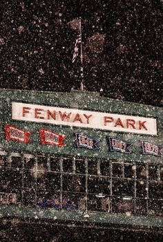 the fenway park sign is covered in snow