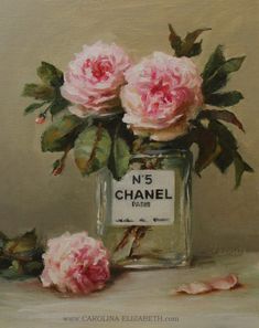 a painting of pink roses in a glass vase with chanel label on the front