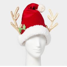 a white mannequin head wearing a red santa hat with reindeer antlers on it