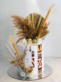 a cake decorated with feathers and flowers on a plate