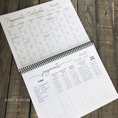 a planner and pen sitting on top of a wooden table