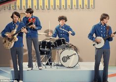 the beatles are on stage with their instruments