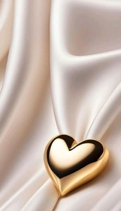 a gold heart on white silk