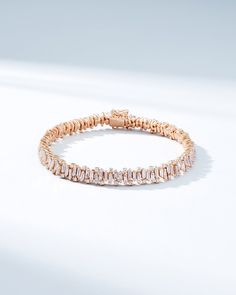 Discover the allure of our Shimmer Diamond Tennis Bracelet, a masterpiece of design and elegance. This bracelet features an artfully organized array of vertically stacked baguette diamonds, alternating with round white diamonds, culminating in a stunning statement piece. Set with 6.5 carats of white diamonds, this bracelet is crafted to capture light and attention, ensuring it sparkles brilliantly on your wrist. Details 18k rose gold, white gold or yellow gold 6.51 carats of baguette and round w Elegant Baguette Tennis Bracelet For Formal Occasions, Elegant Baguette Tennis Bracelet For Formal Events, Elegant Everyday Diamond Bracelet With Baguette Diamonds, Luxury Baguette Diamond Bracelet, Luxury White Gold Tennis Bracelet With Baguette Diamonds, Luxury Diamond Tennis Bracelet With Baguette Cut, Modern Wedding Tennis Bracelet With Baguette Diamonds, Modern Tennis Bracelet With Baguette Diamonds For Wedding, Elegant Baguette Diamond Bracelet For Formal Occasions