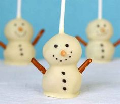 there are four snowmen made out of marshmallows with sticks sticking out of them