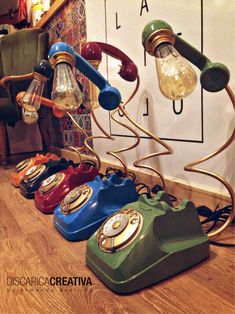 an assortment of old - fashioned telephones are lined up in a row on the floor