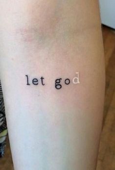 a woman's leg with the word let god tattooed on it, in black ink