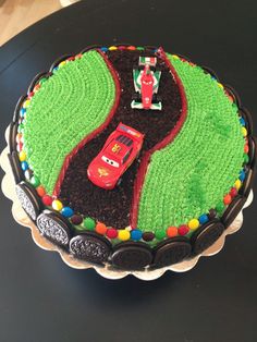 a birthday cake with cars on the road