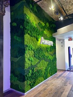 a large green wall in an office with the word awne on it's side