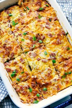 a casserole dish with ham and cheese in it on a blue table cloth