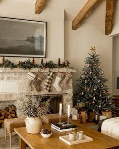 a living room filled with furniture and a christmas tree in front of a fire place