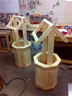 three wooden buckets sitting on top of a workbench