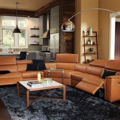 a living room filled with lots of furniture in it's center area and windows