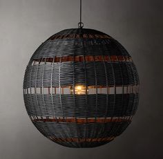 a light that is hanging from the ceiling in a room with grey walls and flooring