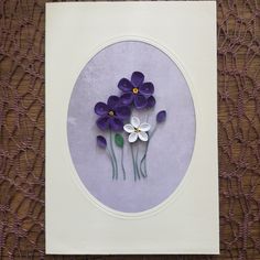 some purple and white flowers are in a circle