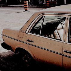 an old car parked on the side of the road