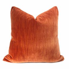 an orange pillow on a white background with the back turned to show it's texture