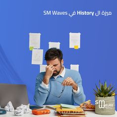 a man sitting in front of a laptop computer on top of a desk with sticky notes all over it