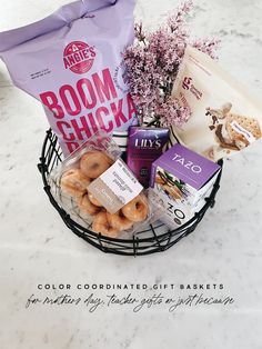 a basket filled with assorted items on top of a marble counter next to a purple bag