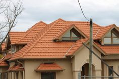 a house with orange shingles on the roof