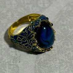 This New Arrival Won’t Be Around For Long! The Enthralling Domed Blue Stone Is Like Looking Into The Depths Of A Tropical Sea. Then Surrounded By Blue And Gold Enamel Detailing That Is Scattered With Shiny Blue Rhinestone Chips. All Set In A Goldtone Setting, It Makes Quite The Statement Ring! A Great Gift For Any Occasion (If You Can Make Yourself Give It Away) Nwt Size 6 Sizes Are Approximate Posh Ambassador Fast Shipping Blue Jeweled Rings For Gifts, Blue Jeweled Rings For Gift, Blue Adjustable Jewelry With Stone Setting, Blue Metal Rings For Wedding, Blue Ring Jewelry For Party, Blue Party Ring Jewelry, Blue Rhinestone Jewelry For Gifts, Blue Stone Setting Jewelry For Party, Blue Party Jewelry With Stone Setting