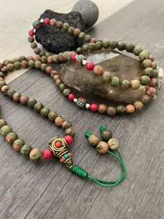 Unique and powerful Unakite Jasper stone Japa mala Necklace from Nepal. A unisex piece that will be perfect for your day by day outfits and will be easy to match any other accessories. If it fits right can be a bracelet also. This is also a Buddhist praying 108 beads mala, you can use this mala to stay grounded and meditate and also to stay in fashion at the same time. You can loosen up the beads to make it easy to meditate with the mala. The mala is 42.5cm- 16.75 inch long A unique addition to Spiritual Green Hand Wrapped Beads, Adjustable Agate Hand-strung Mala, Adjustable Hand Wrapped Mala For Healing, Green Mala With 8mm Beads For Healing, Adjustable Hand-strung Agate Mala, Spiritual Agate Beaded Necklaces For Festival, Spiritual Agate Mala With 108 Beads, Earthy Hand-strung Beaded Necklaces For Meditation, Spiritual Festival Agate Beaded Necklaces