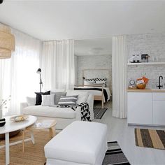 a living room filled with furniture and white walls