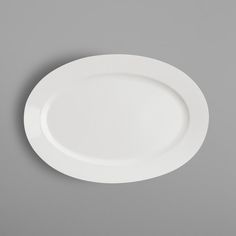 an empty white plate on a gray background