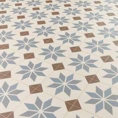 a white and brown tiled floor with small blue stars on the top, in a room