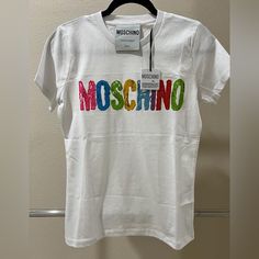 Moschino Couture Painted Multicolor Logo T-Shirt, White , Size S , Hundred Percent Cotton . The Logo Is Vibrantly Colored As Shown In The Photos . White T-shirt With Embroidered Logo For Spring, White Tops With Embroidered Logo For Spring, White Cotton Top With Logo, Trendy White Top With Logo, Casual White Tops With Embroidered Logo, Multicolor Cotton Top With Logo Print, Multicolor Crew Neck Top With Embroidered Logo, Moschino T Shirt, White Teddy Bear