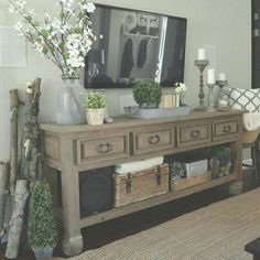 a living room filled with lots of furniture and flowers on top of a wooden table