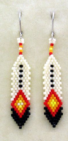 two pairs of beaded earrings with colorful beads hanging from hooks on a white surface