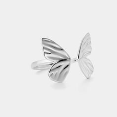 This stunning piece of jewelry artfully crafted with a delicate silver butterfly motif will make an exquisite addition to any jewelry box. The captivating design of the butterfly will bring a unique and sophisticated touch to any ensemble. DETAILS Materials:  Sliver Size: Adjustable Weight:  3.31g Delicate Butterfly White Gold Jewelry, Delicate White Gold Butterfly Jewelry, Fine White Gold Butterfly Jewelry, Silver Jewelry With Butterfly Charm, Silver Jewelry With Butterfly Charm For Formal Occasions, Silver Butterfly Jewelry For Formal Occasions, Silver Butterfly Fine Jewelry, Elegant Adjustable Wing-shaped Jewelry, Elegant Silver Butterfly Ring For Wedding