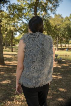 Classic and beautiful Silver Gray Angora faux fur hip length vest with deep pockets on both sides and hidden hook and eye front closure. Extremely soft and luxurious high quality faux fur! Great fitting and easy to wear makes this the perfect way to add a little style to any dressy or casual attire. Fully lined with high quality satin. 100% high quality soft faux fur. Hand made in the USA. Sizes available in S, M, L, XL Hand wash cold, hang to dry. Most items from our shop ship within 1-2 busine Sleeveless Fur Coat With Faux Fur Lining For Fall, Sleeveless Faux Fur Coat For Fall, Sleeveless Faux Fur Vest For Fall, Sleeveless Faux Fur Coat, Sleeveless Mink Outerwear With Faux Fur Lining, Fitted Faux Fur Vest With Faux Fur Lining, Sleeveless Faux Fur Coat With Fur Trim, Sleeveless Fur Coat With Faux Fur Trim, Sleeveless Faux Fur Outerwear