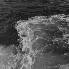 a person riding a surfboard on top of a wave in the ocean