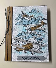 a birthday card with two airplanes flying in the sky, and an envelope that says happy birthday