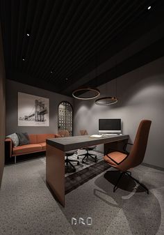 an office with a desk, chair and television in the center is lit by two pendant lights hanging from the ceiling