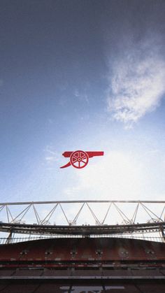 an airplane flying in the sky over a stadium