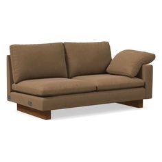 a brown couch with two pillows on it's back and one arm facing the camera