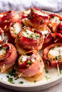 small appetizers are arranged on a plate with toothpicks and parsley