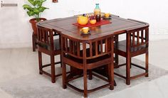 a wooden table with chairs around it and fruit on the plate in front of it