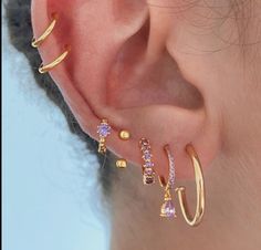 an ear with three different types of piercings on it