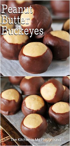 chocolate peanut butter buckeyes on a baking sheet and in the background there is a pile of them