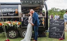 a bride and groom kissing in front of an ice cream truck at their wedding reception