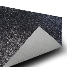 a black and white area rug with silver glitter on the top, in front of a white background