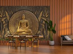 a buddha statue sitting on top of a wooden table in front of a wall mural